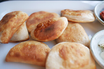 Delicious freshly cooked pastries served on a white platter