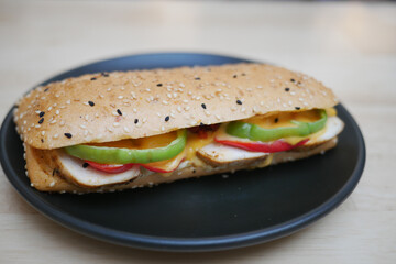 Delicious sandwich with fresh vegetables and grilled chicken