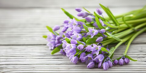 Fototapeta premium Bluebell flowers on a white wooden backdrop 