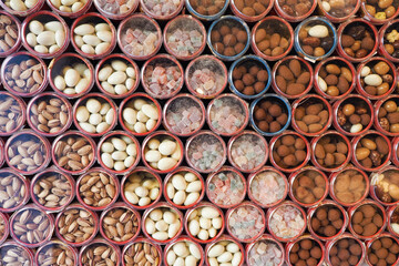 Colorful display of assorted nuts and candies in containers