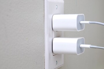 Phone charger plugged into a power outlet