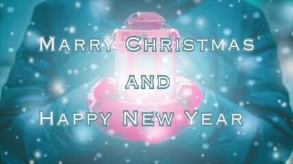 Merry Christmas and Happy New Year words design. Woman in jacket and red gloves holding red lantern candlestick with light coming out during snowfall in winter. Loop seamless animation text background - Powered by Adobe