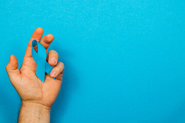 Symbolic blue ribbon representing awareness for cancer detection and prevention