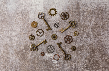 Collection of decorative aged keys with gears on dark background. Flat lay, top view.