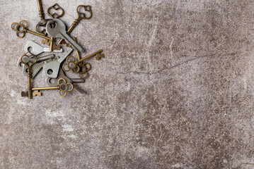 Collection of decorative aged keys on dark background. Flat lay, top view. Copy space