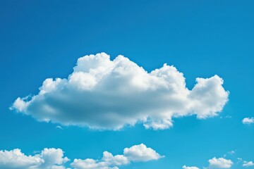 Obraz premium Fluffy white cloud in a clear blue sky enhancing tranquil landscapes and uplifting outdoor settings for nature enthusiasts and travel lovers