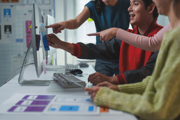 Web designers collaborating on color palettes for a new website interface, discussing ideas and...