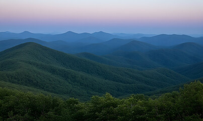 Serene twilight view of rolling blue mountains, showcasing layers of forested hills under a soft pastel sky.  Perfect for nature, travel, and calmness themes.