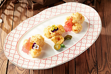 Prawn balls with cheese sauce, mustard and honey