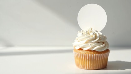 Delicious cupcake with white icing, blank topper. Customizable design mock-up. Sweet vanilla cream confectionery with edible sugar pearls. Advertising background for presentation of labels branding