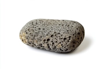 Obraz premium A smooth gray volcanic rock sits on a white background. This natural element symbolizes strength and resilience. Perfect for various creative projects. Generative AI
