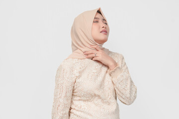 An Asian Muslim woman feels so thirsty because of the hot weather during the summer season.