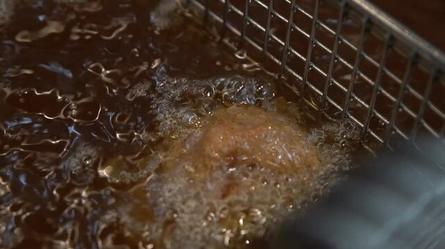 Deep frying Korean fried chicken in boiling oil.