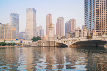 Fototapeta premium The urban architectural skyline, modern bridges, and Haihe River scenery of Tianjin, China on August 15, 2024 