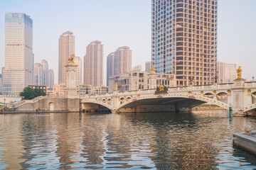 Obraz premium The urban architectural skyline, modern bridges, and Haihe River scenery of Tianjin, China on August 11, 2024 