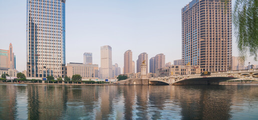 Obraz premium The urban architectural skyline, modern bridges, and Haihe River scenery of Tianjin, China on August 11, 2024 