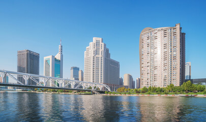 Fototapeta premium The urban architectural skyline, modern bridges, and Haihe River scenery of Tianjin, China on August 11, 2024