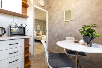 Cozy Kitchen with White Table and Green Plant