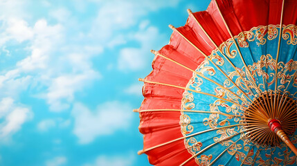 Colorful Red and Blue Umbrella with Intricate Design Against Sky