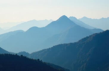 Serene mountain range layers at dawn with soft misty light