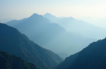 Fototapeta premium Serene morning mist over layered mountain ranges in tranquil landscape
