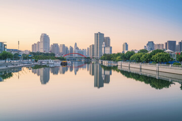 Obraz premium The urban architectural skyline, modern bridges, and Haihe River scenery of Tianjin, China on August 11, 2024