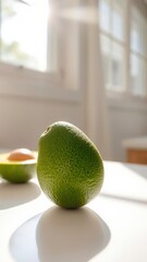  Simple Avocado Resting on a White Countertop, Illuminated by Sunlight Streaming In