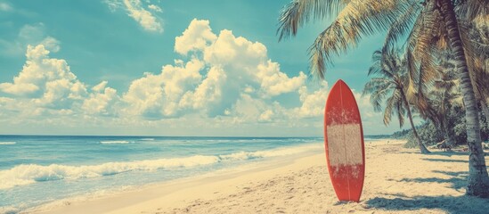 Vibrant tropical beach scene featuring a red surfboard on golden sand with palm trees, turquoise water, and fluffy clouds under a bright sky.