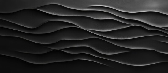 Fototapeta premium Textured black clay background featuring smooth wavy patterns with variations in light and shadow creating depth and visual interest