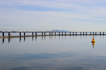 Fototapeta premium pier over still seawater at waterfront city of Geelong