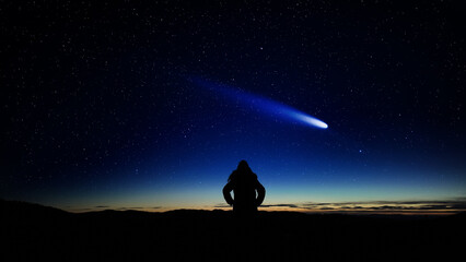 Woman observing comet, shooting stars, planets and Milky Way Stars from a dark countryside location.