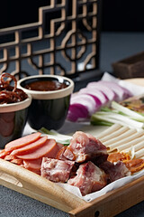 A large platter of braised meat dishes and pickles