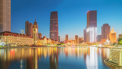 Obraz premium The urban architectural skyline, modern bridges, and Haihe River night scenery of Tianjin, China on August 11, 2024 ﻿