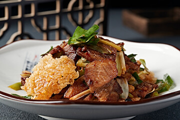 Stir-fried pork with garlic sprouts and rice crust