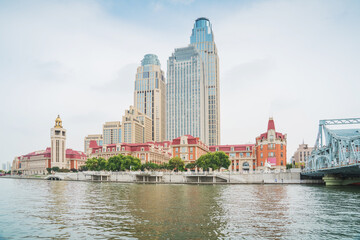 Obraz premium The urban architectural skyline, modern bridges, and Haihe River scenery of Tianjin, China on August 11, 2024