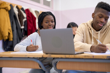Students studying and learning together in institute classroom