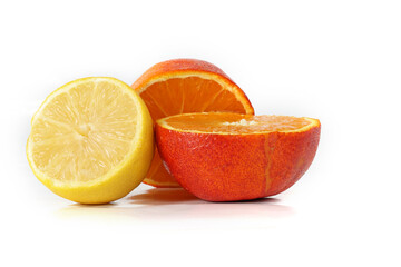 Lemon and oranges cut in half on a white background