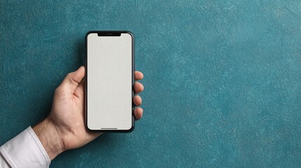 A hand holds a smartphone against a textured teal background, showcasing a blank screen ready for customization or content.