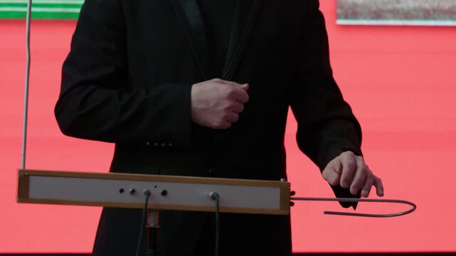 Playing the theremin. The theremin, etherphone, thereminophone or termenvox, thereminvox, is an electronic musical instrument controlled without physical contact by the performer. Patented in 1928