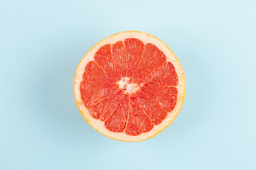 Grapefruit on blue background, top view, flat lay