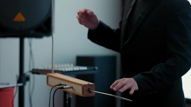 Playing the theremin. The theremin, etherphone, thereminophone or termenvox, thereminvox, is an electronic musical instrument controlled without physical contact by the performer. Patented in 1928