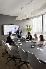 Boardroom presentation. Focused businesspeople group of diverse gender age gather by conference...