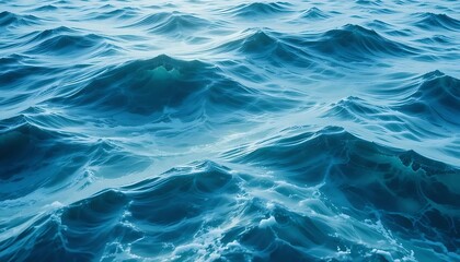 Fototapeta premium Serene Ocean Waves in Shades of Blue with Gentle Ripples and Intricate Water Patterns Under Bright Light