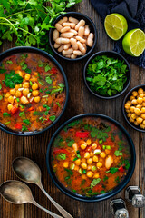 Fresh vegetable soup with chickpea on wooden table 