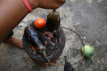 Roasting eggplant or Brinjal on a coal stove. By Roasting and Mashed it, a famous dish Baingan Ka...