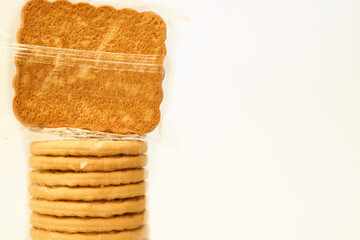 Tasty cookies in a protective cellophane package for sale on a white 