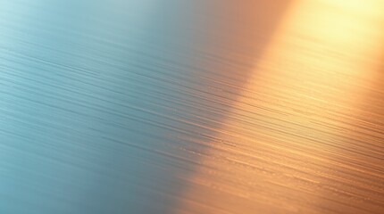 A close-up of brushed metal shows a gradient of cool blue into warm yellow tones creating an abstract backdrop.