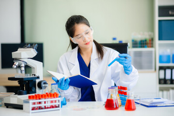 Discover a dedicated scientist conducting laboratory research, using pipettes, microscopes, and lab...