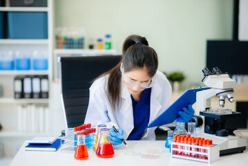 Discover a dedicated scientist conducting laboratory research, using pipettes, microscopes, and lab...