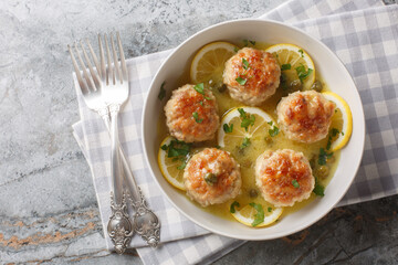 Italian chicken meatballs with picatta sauce consisting of capers, butter, lemons, and wine...